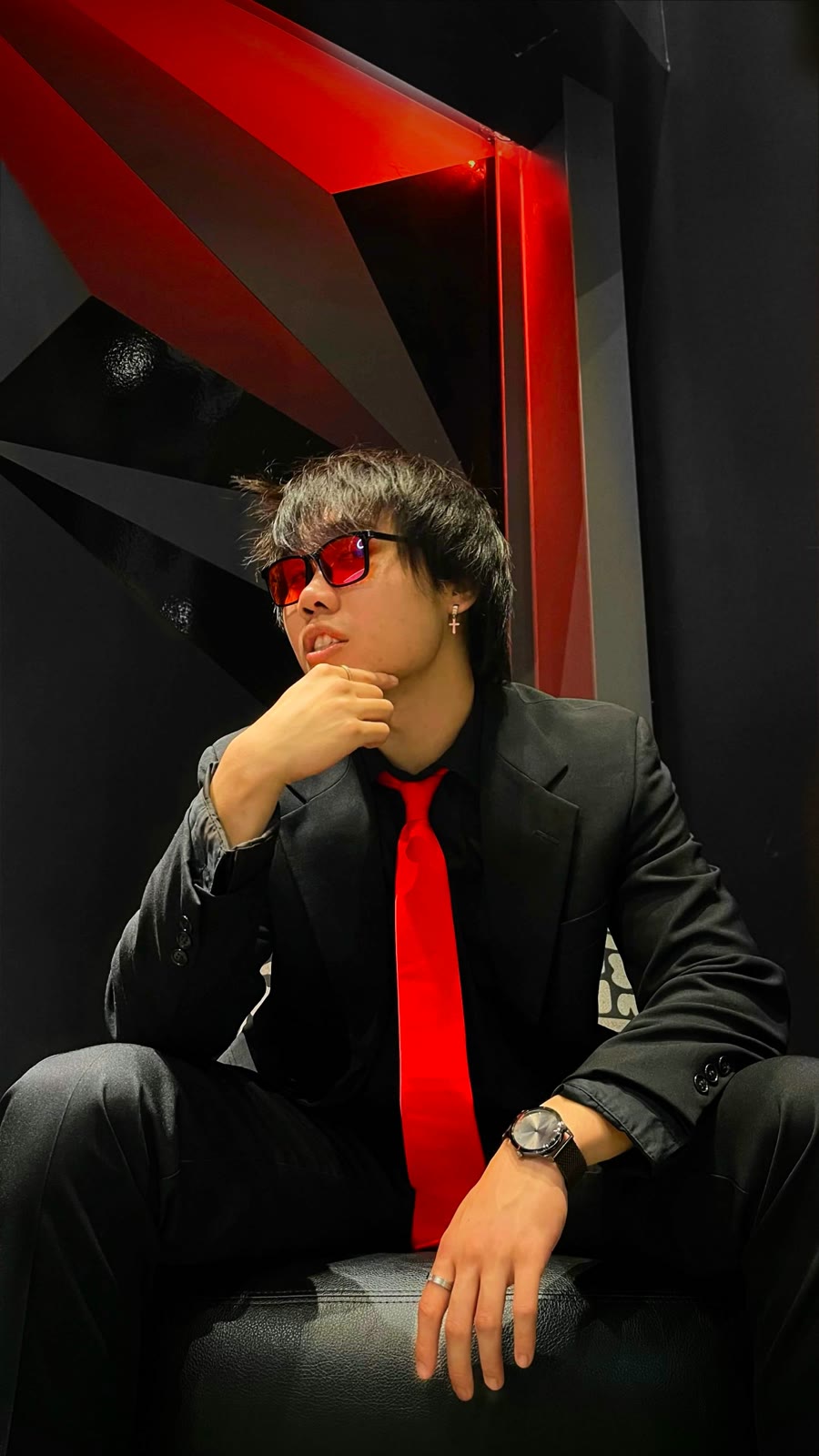 Josiah Phou in a black suit and red tie